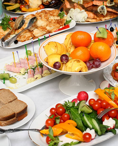fresh vegetables, fruits and appetizers on served banquet table stock photo