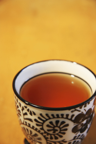 Cup of lemon tea with a slice of lemon and mint, drop of lemon tea cup