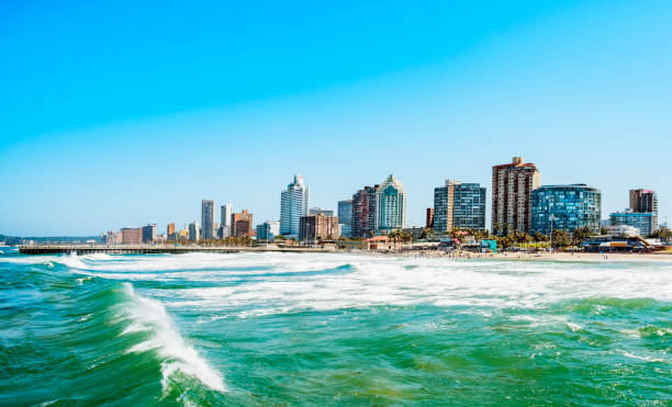 durban skyline waterside Panorama photo of Durban South Afrika. Big waves crossing the scene zululand stock pictures, royalty-free photos & images