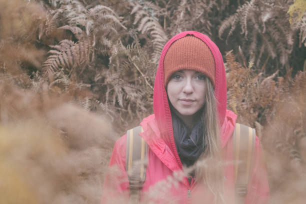 Woman in the rain forest surrounded by tree fern