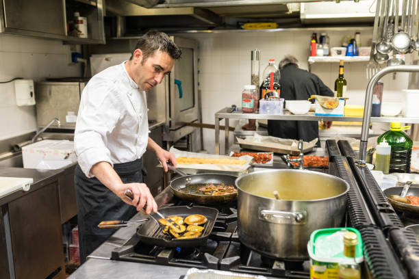 istock Chef in a restaurant kitchen cooking meat and mushrooms 891527262