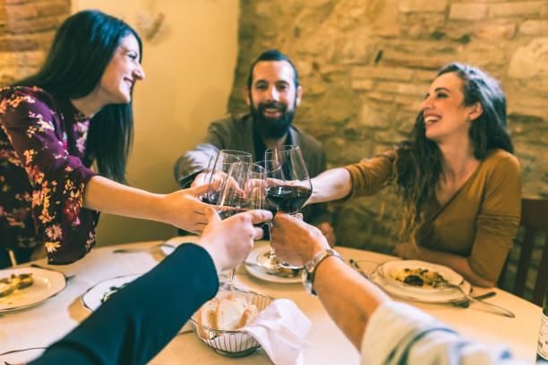 istock People toasting with red wine at restaurant 891527368