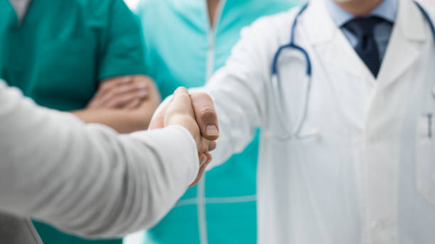 istock Doctor and patient giving an handshake 891531038