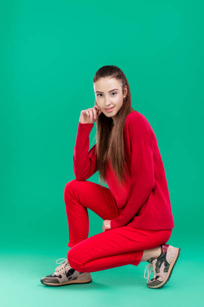 woman in red sweater on green background