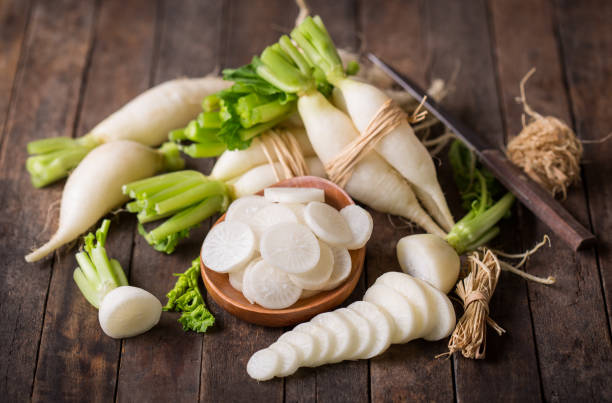 White organic radishes on the wooden table stock photo