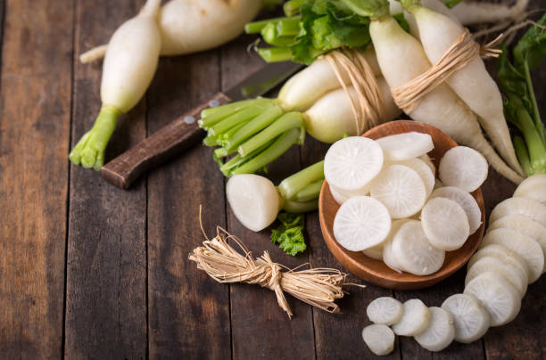 White organic radishes on the wooden table stock photo
