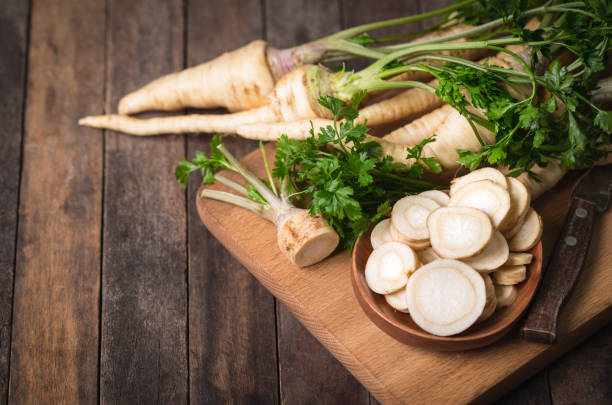 Fresh parsley root on the wooden table stock photo