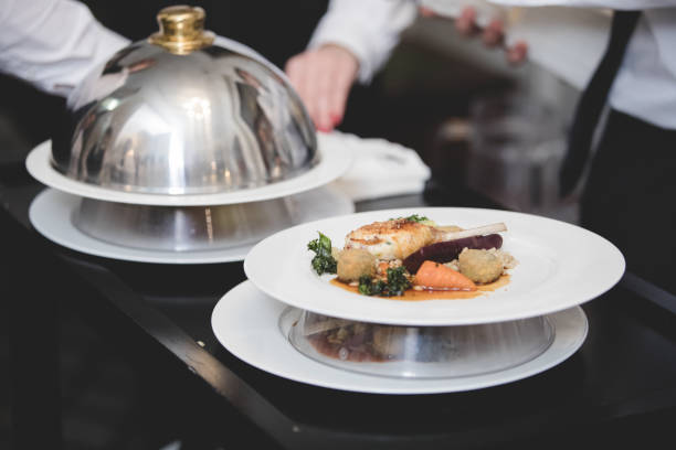 istock Chicken and vegetables on plate being served off trolley 891536502