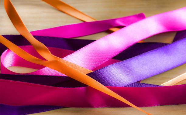 istock Ribbons on wooden background 891537690