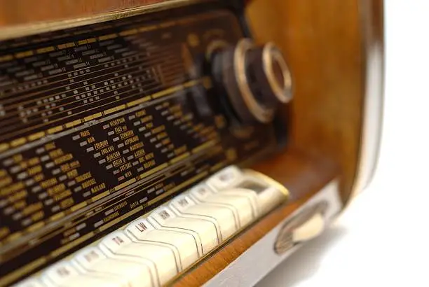Antique tube-radio furniture from 1955, close-up from the tuner scale, selective focus.