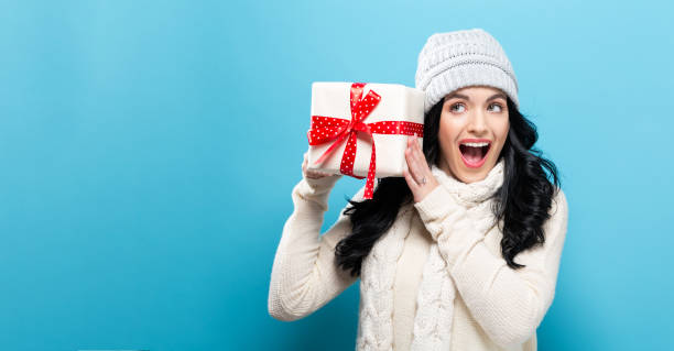 istock Young woman holding a Christmas gift 891540556