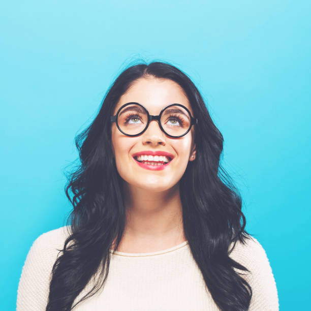 istock Young woman looking upward 891540636