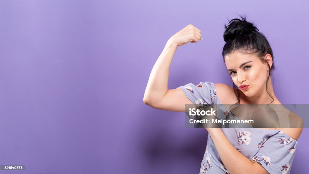 Powerful young woman in a success pose Powerful young woman in a success pose on a solid background Confidence Stock Photo