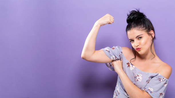 Powerful young woman in a success pose Powerful young woman in a success pose on a solid background womens issues stock pictures, royalty-free photos & images