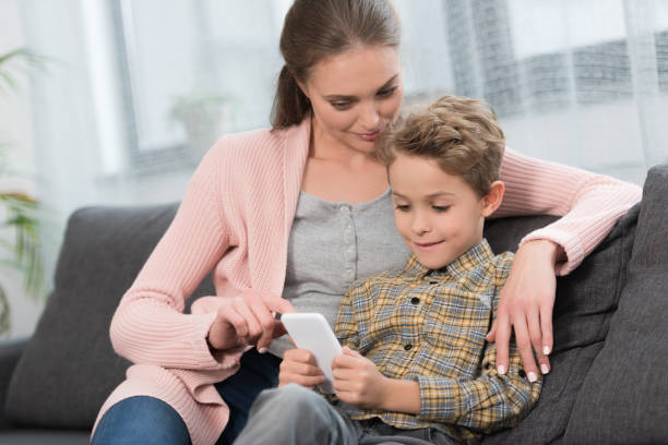 istock Mother showing something on smartphone 891541228