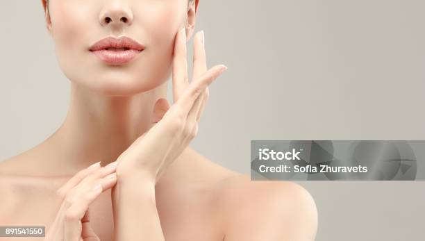 Gorgeous Young Woman With Clean Fresh Skin Is Touching Own Face Cosmetology Stock Photo - Download Image Now