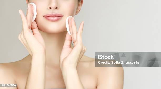 Young Beautiful Woman Model Is Moisturing Own Face Skin By Cotton Pads Cosmetology Stock Photo - Download Image Now