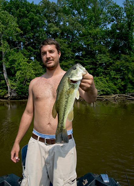 istock Young man holding large mouth bass 89154226
