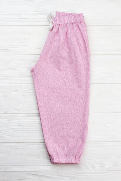 istock Pink pajama pants on white 891549434