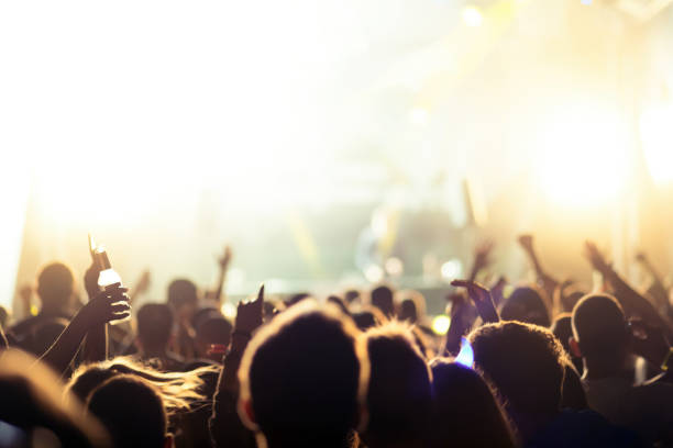 istock People dancing at concert 891550220