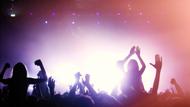 istock People dancing at concert 891550382