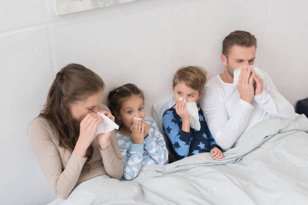 istock family blowing noses in napkins 891560128