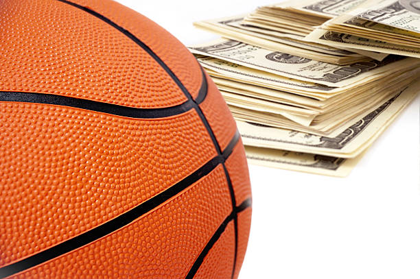 istock basketball ball on background of dollars. 89157254