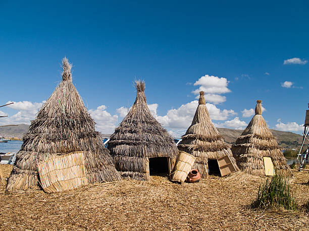 Three teepees on Uros Island on Lake Titicaca in Peru