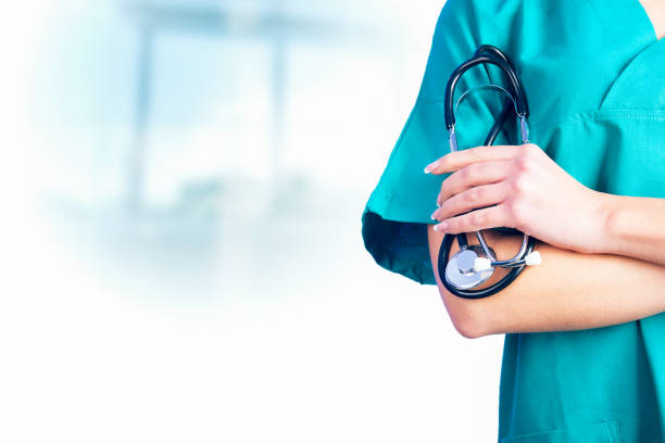 Female Doctor holding a stetoschope in her hands Female Doctor holding a stetoschope in her hands coat garment photos stock pictures, royalty-free photos & images
