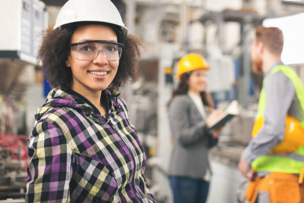 istock Workers in factory working with machines 891585724