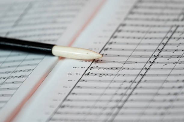 istock Score and baton of the conductor 891585848