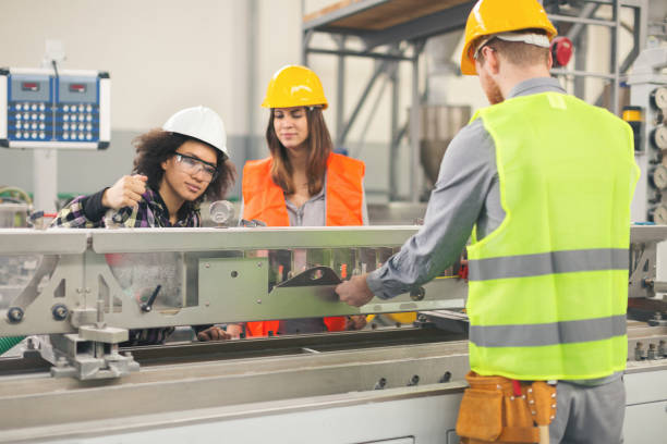 istock Workers in factory working with machines 891585928