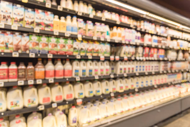 istock Blurred selection of dairy products in open front cold fridge 891586254