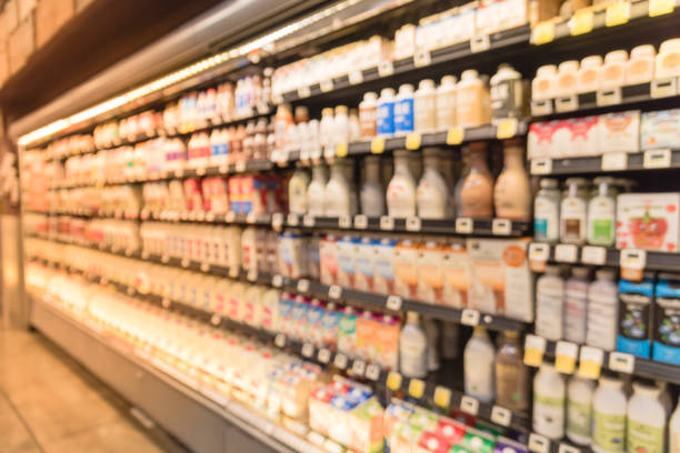 istock Blurred selection of dairy products in open front cold fridge 891586426