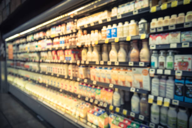 istock Blurred selection of dairy products in open front cold fridge 891586484