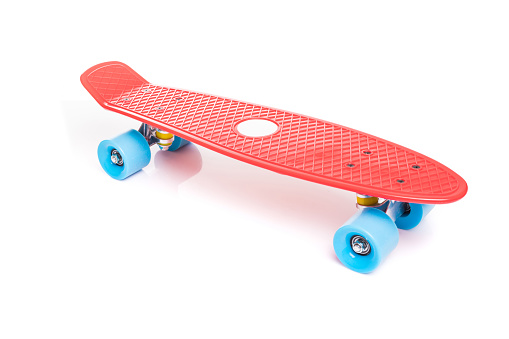 Red plastic skateboard isolated on white background