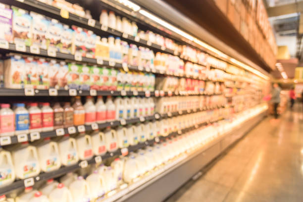 istock Blurred selection of dairy products in open front cold fridge 891588778