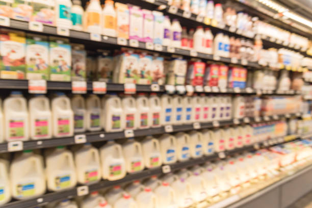 istock Blurred selection of dairy products in open front cold fridge 891588994