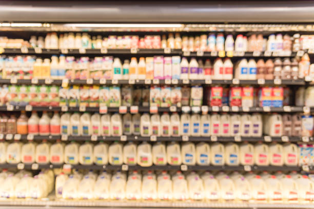 istock Blurred selection of dairy products in open front cold fridge 891589104
