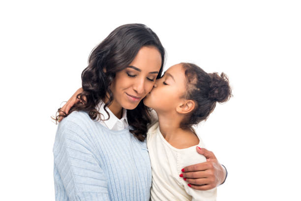 african american mother and daughter adorable african american daughter kissing happy mother isolated on white the black womens expo stock pictures, royalty-free photos & images