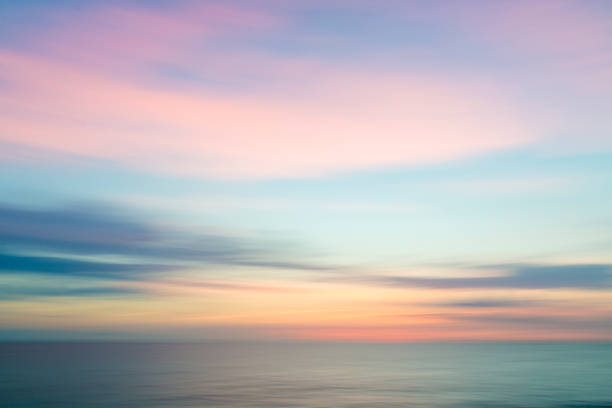 istock Abstract sunset sky and ocean nature background with blurred panning motion. 891596556