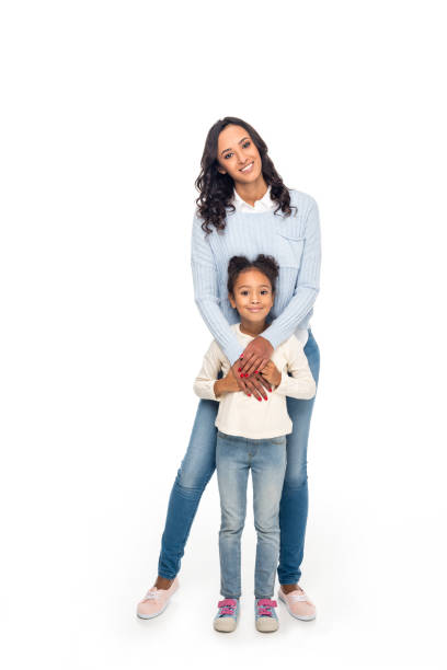 african american mother and daughter full length view of beautiful happy african american mother and daughter smiling at camera isolated on white the black womens expo stock pictures, royalty-free photos & images