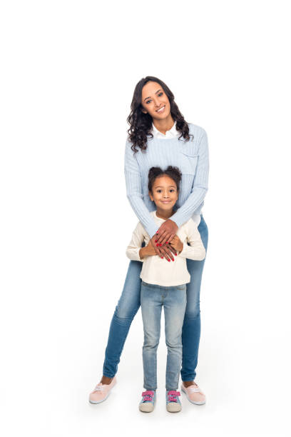 african american mother and daughter full length view of beautiful happy african american mother and daughter smiling at camera isolated on white smiling kids on white stock pictures, royalty-free photos & images