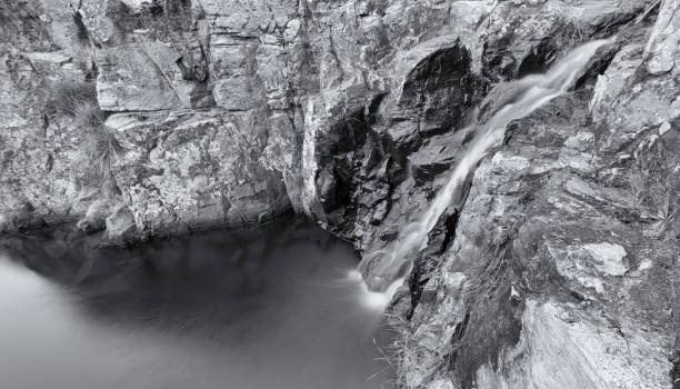istock Small waterfall landscape with long exposure high in river 891597350