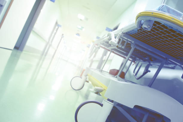 istock Bright clinic hallway with gurney 891597918