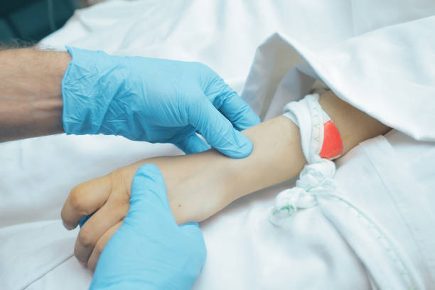 istock Doctor feeling patient`s pulse in ICU 891598990