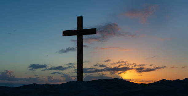 istock An old cross on a sand dune next to the ocean with a calm sunrise 891601570