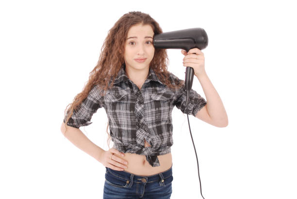 istock Young girl using hairdryer 891601714