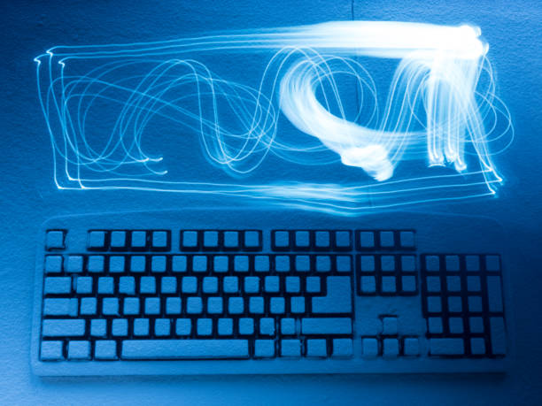 istock computer keyboard covered with snow illuminated by blue light with traces from drawing by freezelight 891602024