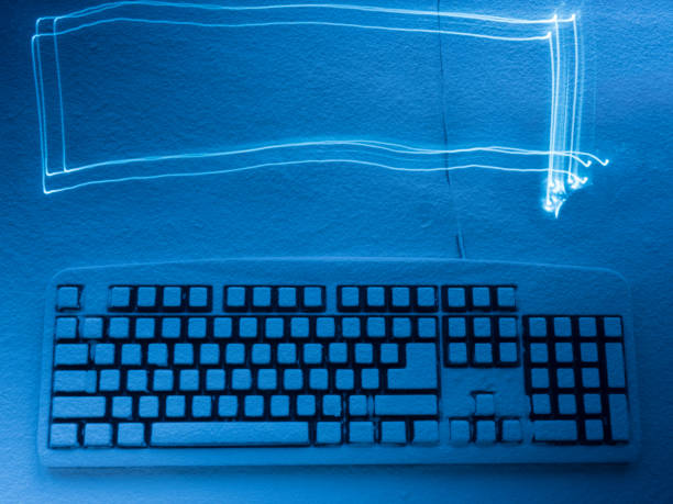 istock computer keyboard covered with snow illuminated by blue light with traces from light drawing copyspace 891602044